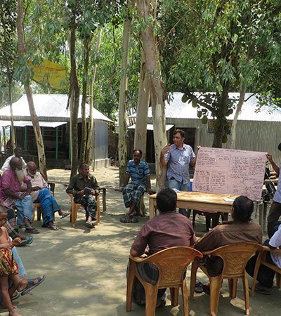 Bangladeshi rural community members gathered at a local community meeting