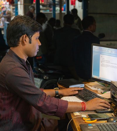 Young Bangladeshi entrepreneur working on a laptop in a technology startup environment