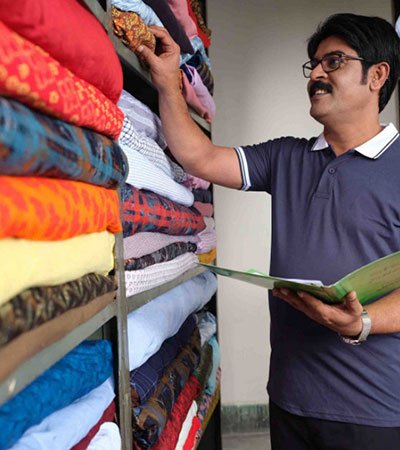 Bangladeshi microenterprise owner working in a small shop